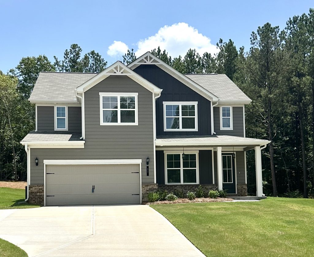a craftsman style home with dark exterior colors