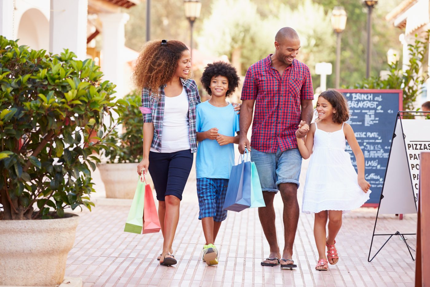 Family shopping outside Monkey Business Images © Shutterstock