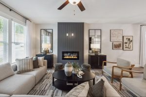 Modern living room in a new Gainesville, GA townhome with neutral tones, cozy seating, and fireplace.