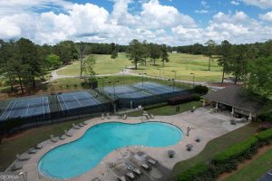 Poolside view with golf course and tennis courts in Villa Rica community.