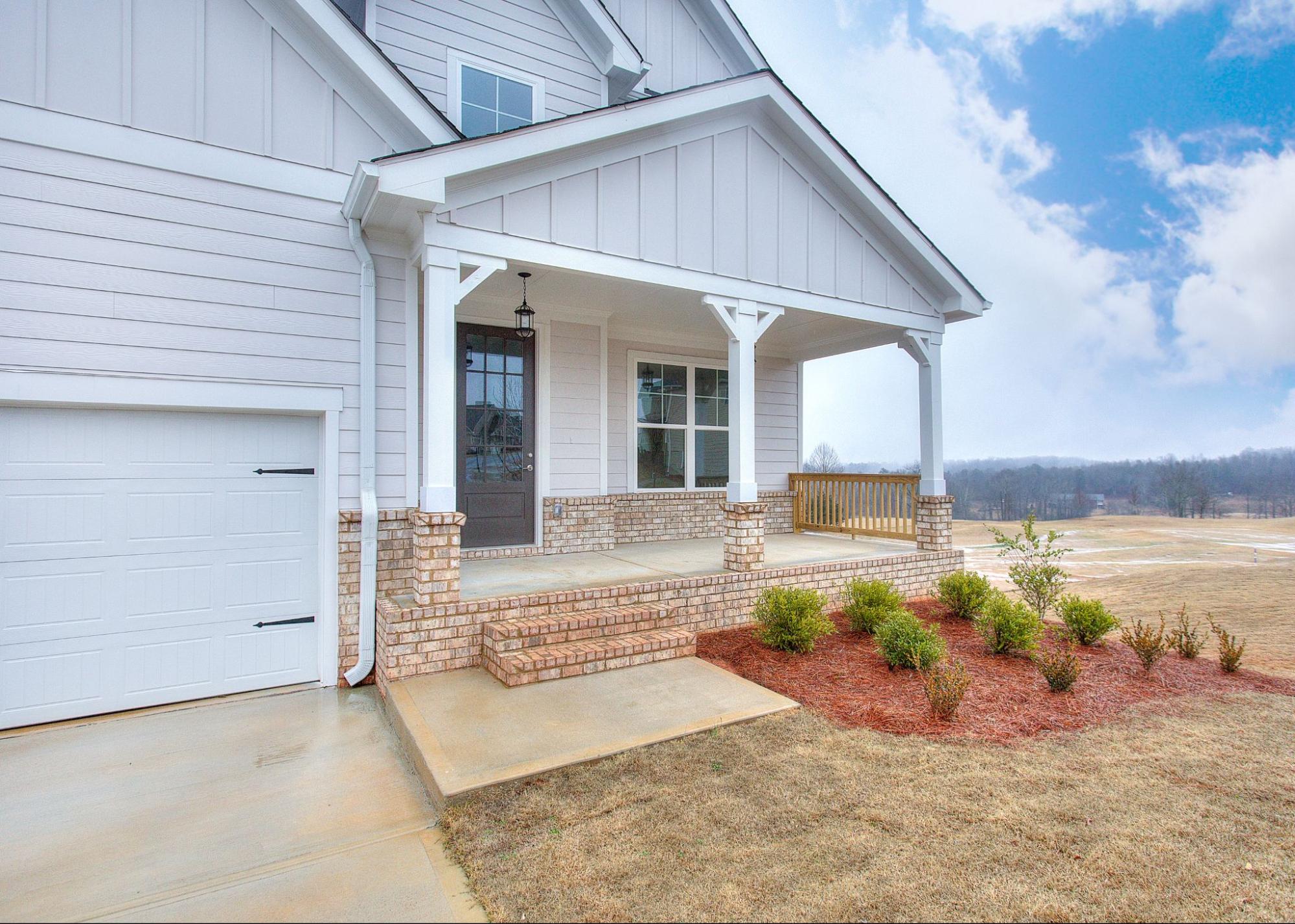 Covered front porch of a new single-family home in The Fairways at Mirror Lake.
