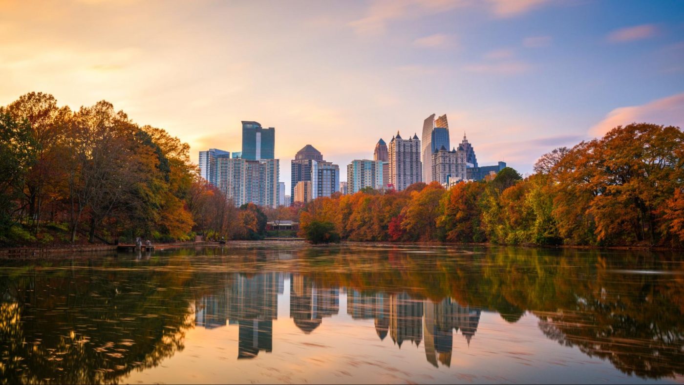 Atlanta skyline reflected in Piedmont Park lake with fall foliage. ©Sean Pavone