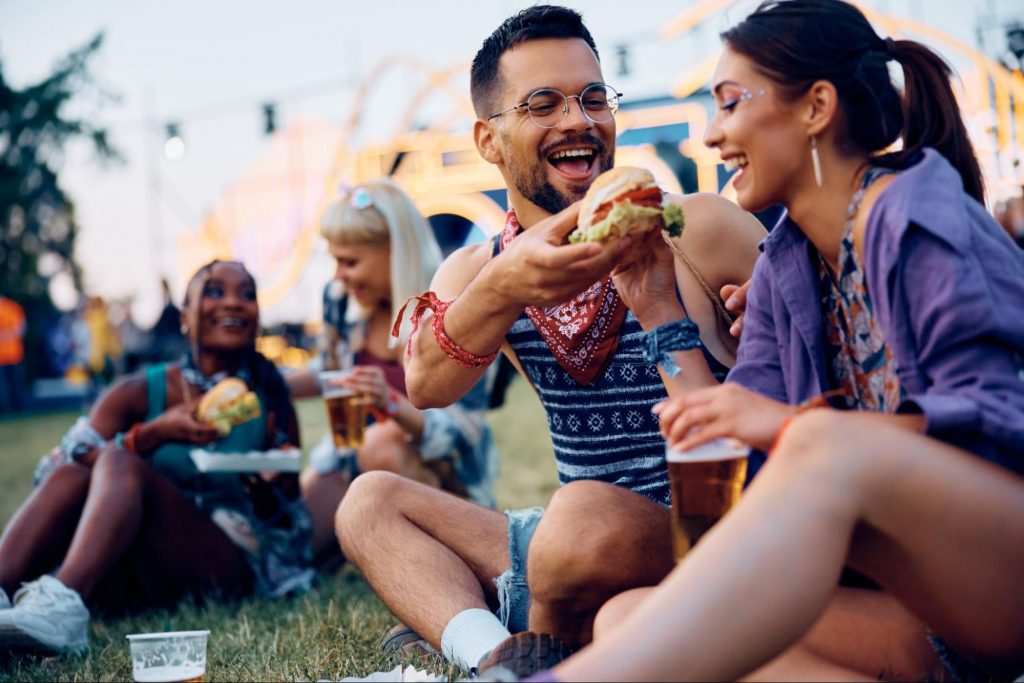 Friends enjoying food and drinks at a fall festival in Atlanta.
©Drazen Zigic