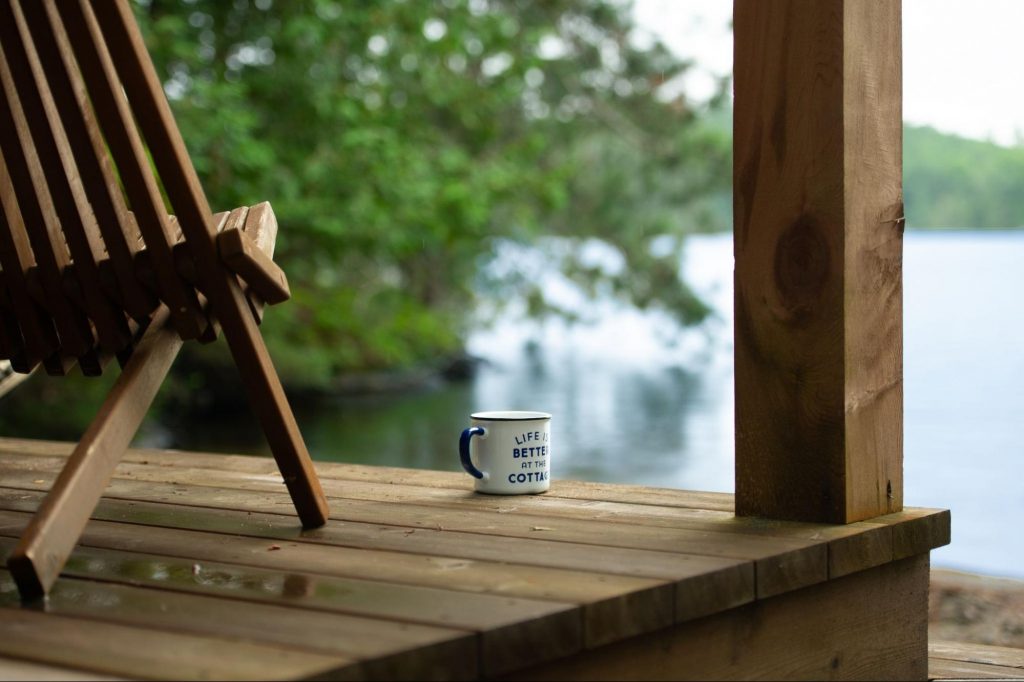 Porch view of Jackson Lake with an Adirondack chair and coffee mug.
©Alessandro Cancian