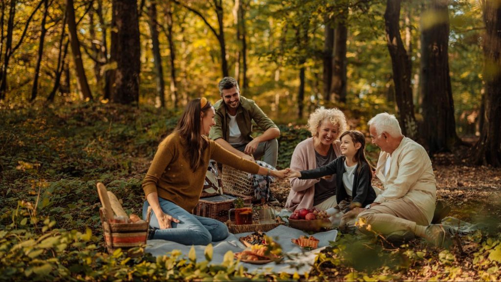 Family enjoying a fall picnic in the woods surrounded by golden autumn leaves near Macon, GA
©bbernard