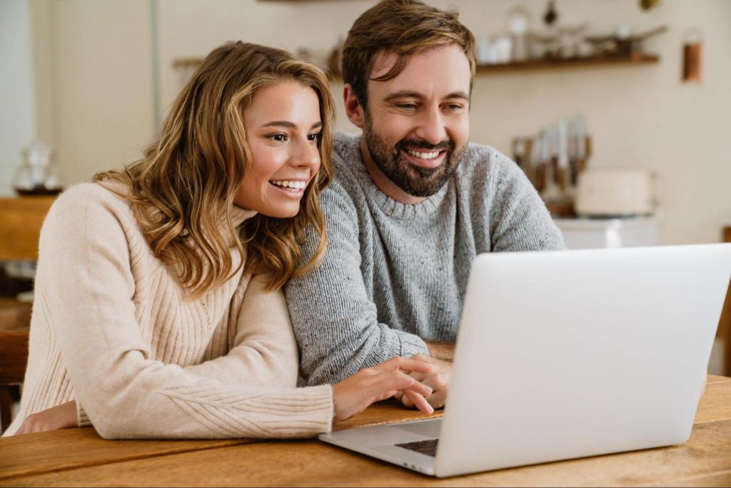 Happy couple viewing new construction homes online 
©Dean Drobot