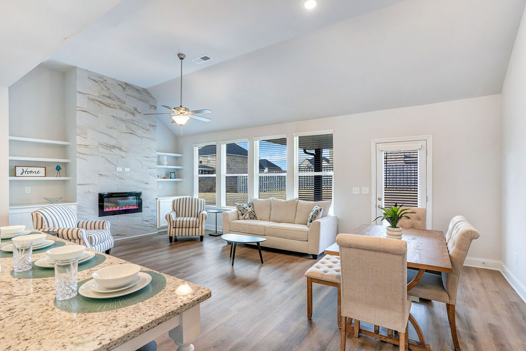Open-concept living room and kitchen with modern finishes and natural light.