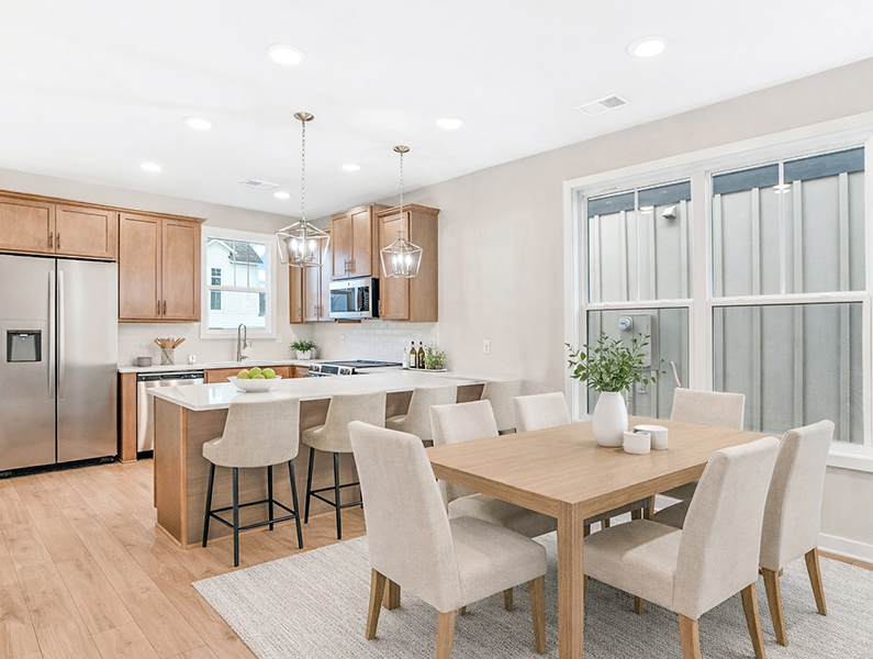 Christine Plan kitchen and dining area at The Cottages at East Lanier in Fayetteville, GA with stainless steel appliances and open layout.