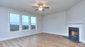 Living room with fireplace in a new Chimney Oaks Overlook home