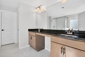 Contemporary primary bathroom with double vanity and walk-in glass shower

