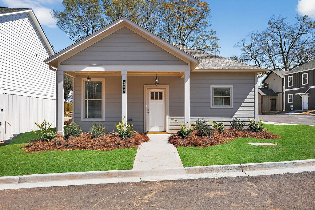Exterior of a craftsman-style single-family cottage with a front porch at The Cottages at East Lanier.